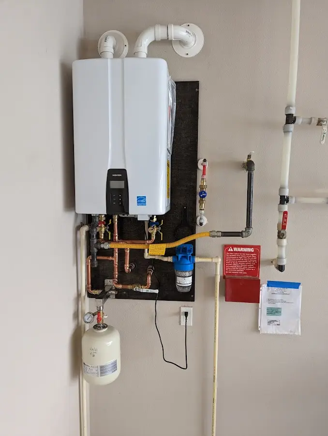 Professional plumber installing copper piping in a Cherryville home